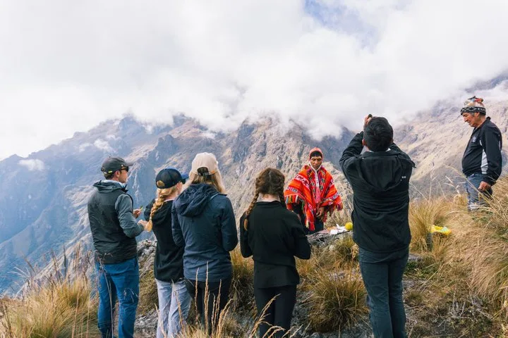 Hikers on a stone path in the Andes on a private luxury Inca Trail tour toward Machu Picchu, Cusco, Peru