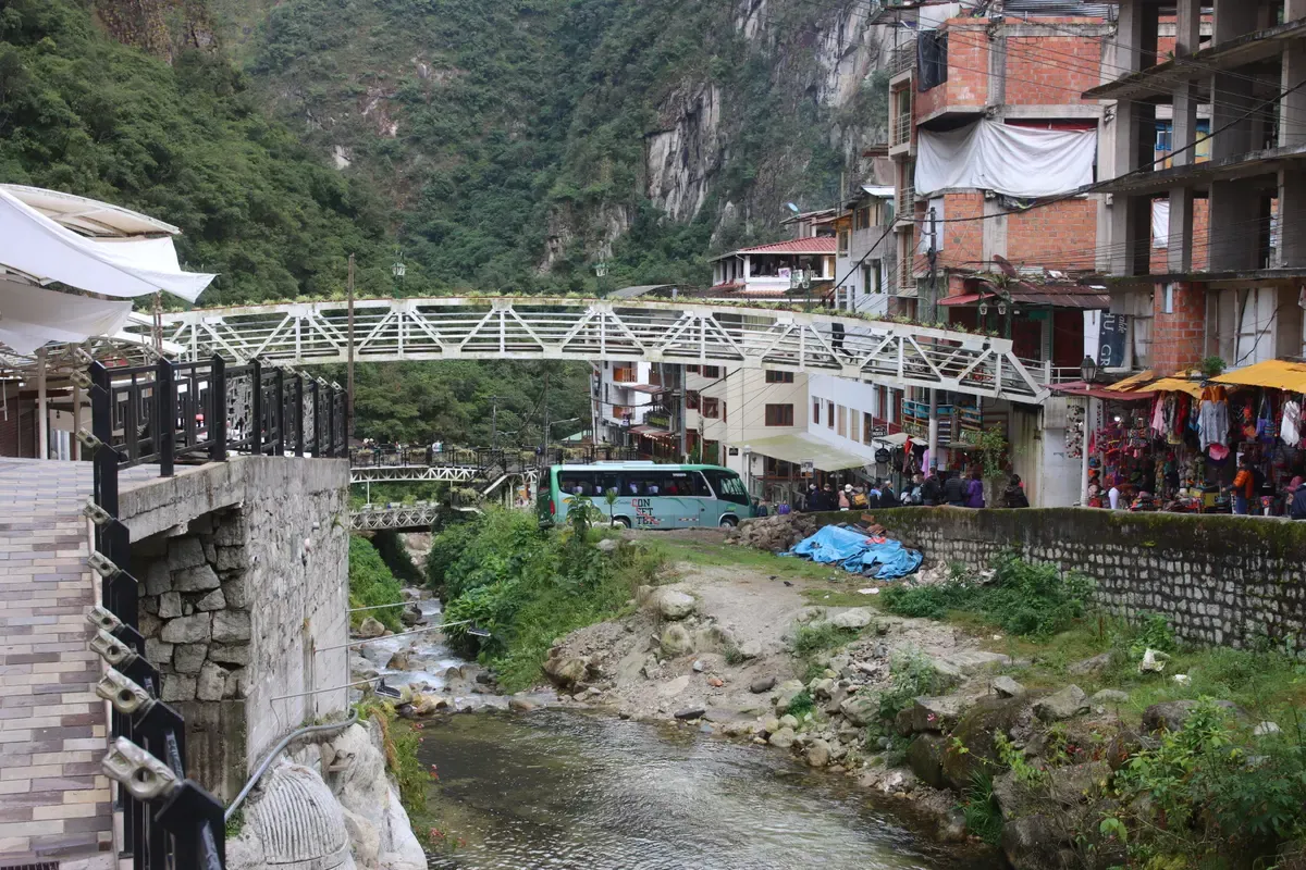The river and footbridge in Aguas Calientes, the train town at the end of luxury Inca Trail tours