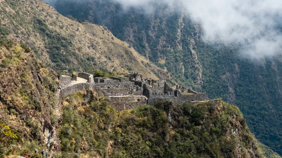 The Sayacmarca ruins on a cliff spur above the cloud forest, passed on day 3 of luxury Inca Trail tours